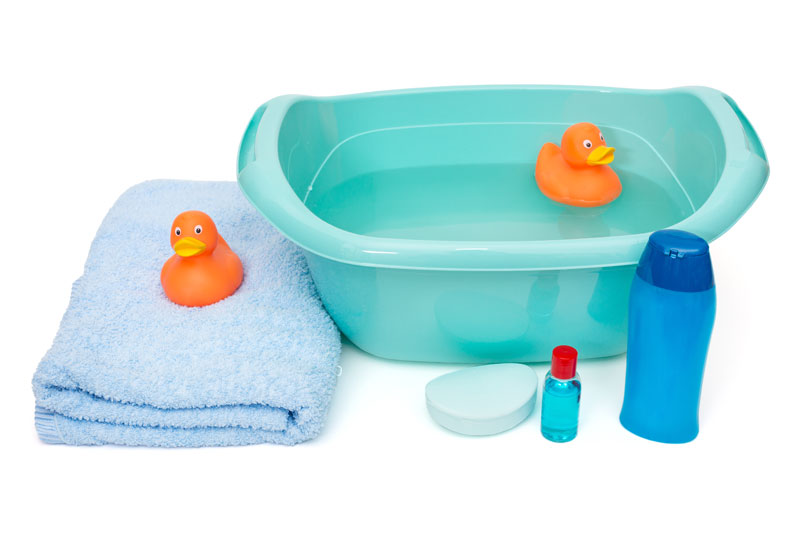 Basic newborn bath essentials including tub, towel, soap, and shampoo